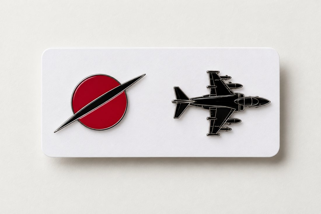 Two enamel pins on a white card: the team mark and a Harrier silhouette